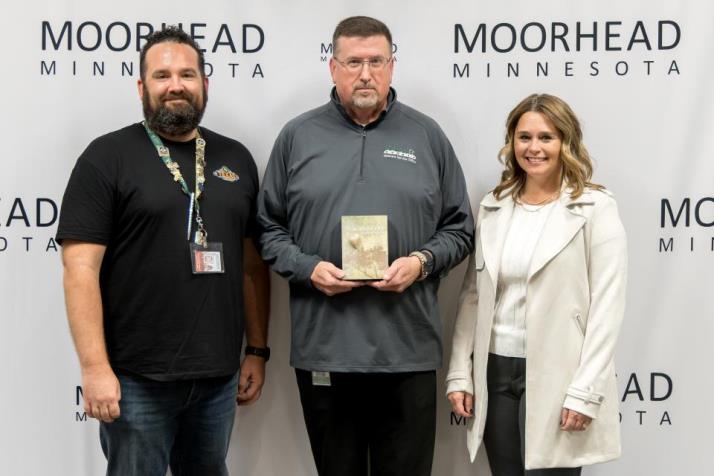 This photo shows Curt Cannon winning the MoorHeart Award with Mayor Shelly Carlson